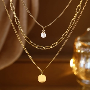 Three-layer gold stainless steel necklace with faux pearl and round medallion pendant