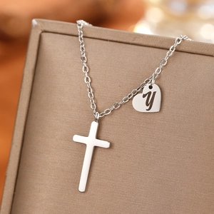 Detail of stainless steel necklace with cross pendant and engraved heart letter Y