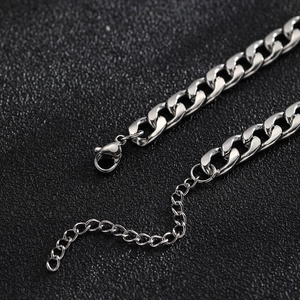 Detail of adjustable lobster clasp on silver-tone stainless steel curb chain bracelet