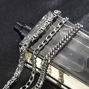 Close-up of stainless steel Cuban and Byzantine chains showing punk textures and luster