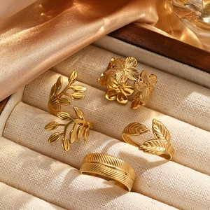 Close-up of golden leaf and flower rings displayed in a velvet jewelry gift box