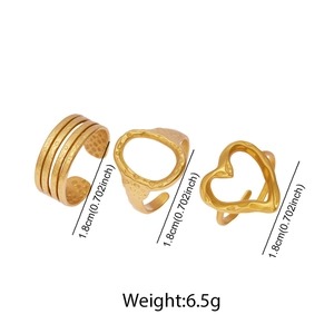 Detailed view of three gold adjustable rings featuring textured heart and hollow designs