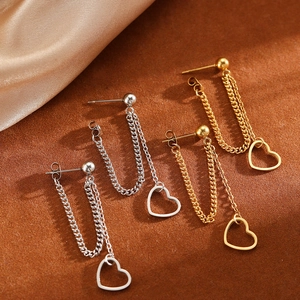 Detail view of heart-shaped drop earrings with double chains in gold and silver finish