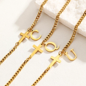 Golden stainless steel anklets with cross and alphabet pendants on Cuban chains