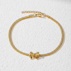 Detail of 18K gold butterfly pendant on snake chain anklet with lobster clasp