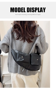Model view of black crescent sling bag with silver metal zippers and front flap pockets