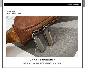 Detail of silver double zippers and reinforced stitching on brown leather chest bag