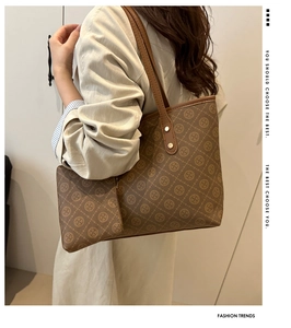 Close-up of vintage brown plaid tote bag with matching zippered pouch and monogram pattern