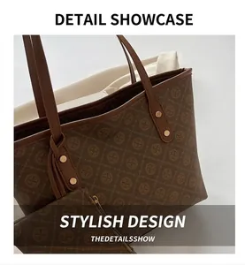 Detail of brown tote bag with logo embossing and matching small zippered pouch