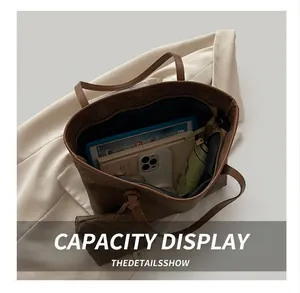 Macro view of a classic brown patterned tote bag showing large storage capacity