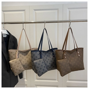 Detail showing vintage tote bags in three colors with matching pouches and monogram print