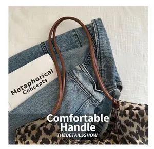 Macro shot of large leopard print tote bag paired with blue denim jeans for casual style