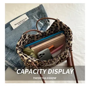 Spacious leopard print tote bag interior showing capacity for tablet, umbrella, and wallet