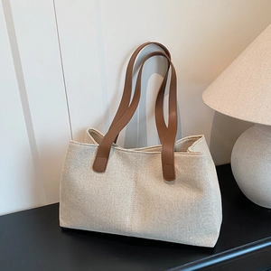 Large capacity canvas tote bag with brown leather handles for women commuting and daily casual use
