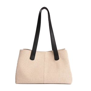 Minimalist beige canvas tote bag with black leather straps for daily commute use