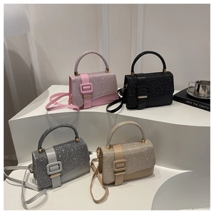 Detailed display of four glitter crossbody bags in pink, black, silver, and champagne gold