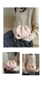 Detail of pink quilted drawstring makeup bag with diamond texture and black embroidery