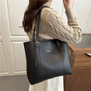 Fashionable black faux leather tote bag for women with adjustable shoulder strap