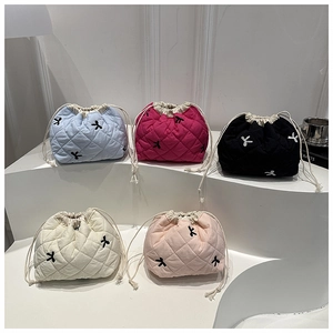 Detailed view of quilted cotton drawstring makeup bags with cute bunny embroidery in five colors