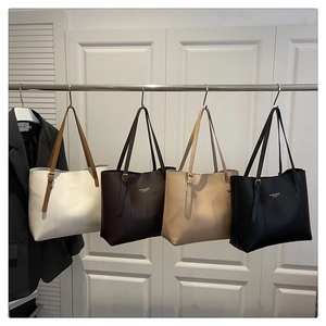 Detail of multi-color minimalist tote bags with adjustable metal buckles and logo