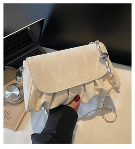 Detailed view of the off-white pleated PU leather chain bag with metal ball decoration