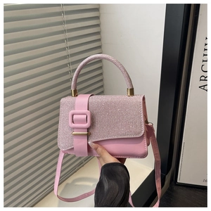 Detailed shot of pink crossbody bag featuring shimmering sequins and golden hardware