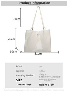 Macro shot of white PU leather tote bag detailing the delicate metal bow accent