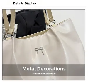 Close-up of glossy wrinkled leather tote with silver bow metal charm detail