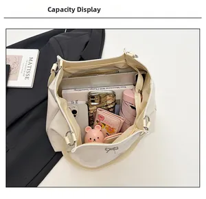 Internal view of a large white tote bag showing storage for laptop and daily essentials