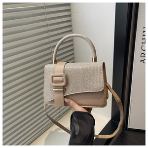 Close-up of stylish beige crossbody bag featuring champagne gold sequins and square buckle