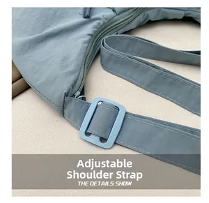 Detail of adjustable strap buckle and durable fabric on light blue tote bag