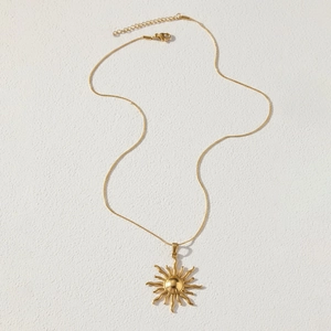 Detail of sunflower pendant necklace with golden plating and lobster claw clasp closure