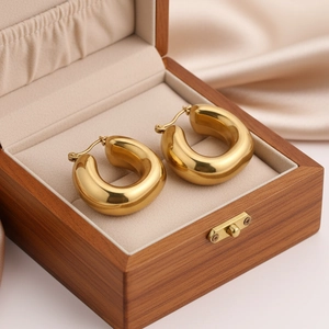Polished gold U-shaped drop earrings for women displayed in a premium wooden jewelry box
