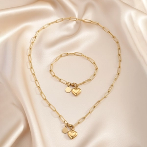 Détail du pendentif cœur doré et disque sur ensemble collier et bracelet maille trombone