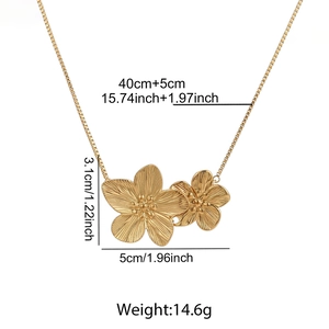 Detail of gold flower pendant with brushed texture and dimensions 3.1cm x 5cm on box chain