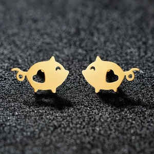 Golden stainless steel pig stud earrings with heart cutout on dark textured background