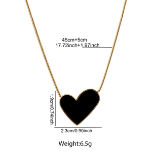 Detailed view of black heart pendant with size markers on 18K gold snake chain