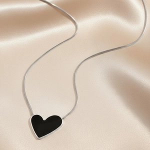 Minimalist black enamel heart pendant necklace with silver snake chain on silk