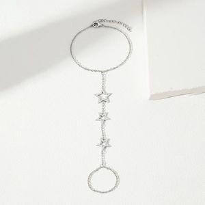 Elegant stainless steel finger bracelet with hollow star design on a clean white background