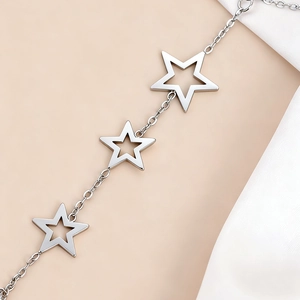 Polished silver stainless steel bracelet featuring three hollow star charms on fine chain