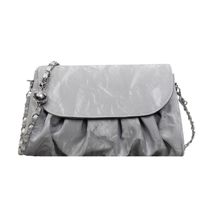 Chic gray pleated cloud crossbody bag with silver chain strap and metal charm pendant