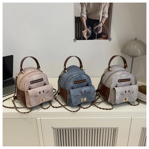 Detailed collection of mini cat-shaped backpacks in pink, blue and grey with chain straps