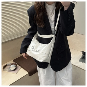 Minimalist white semi-circle leather bag with silver metal buckle on a model