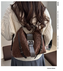 Detail of vintage leopard print hobo bag with brown leather strap and metal buckle