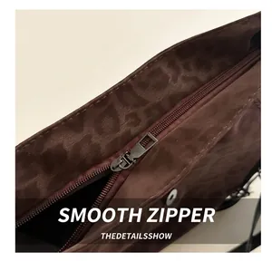 Close-up of leopard print tote bag featuring smooth metal zipper and brown velvet texture