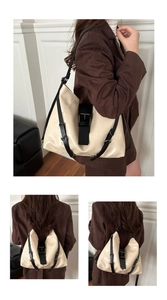 Detail view of large cream leather tote bag with black straps in lifestyle setting