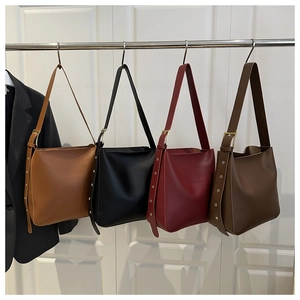 Detailed display of minimalist bucket bags in tan, black, burgundy and dark coffee brown