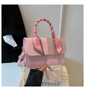 Detailed view of pink crossbody bag with sequin patchwork and scarf wrapped handle