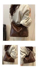 Close-up of retro brown hobo bag showing fine leather texture and gold hardware details