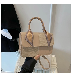 Detail of minimalist cream crossbody bag with sequin patchwork and silk scarf handle